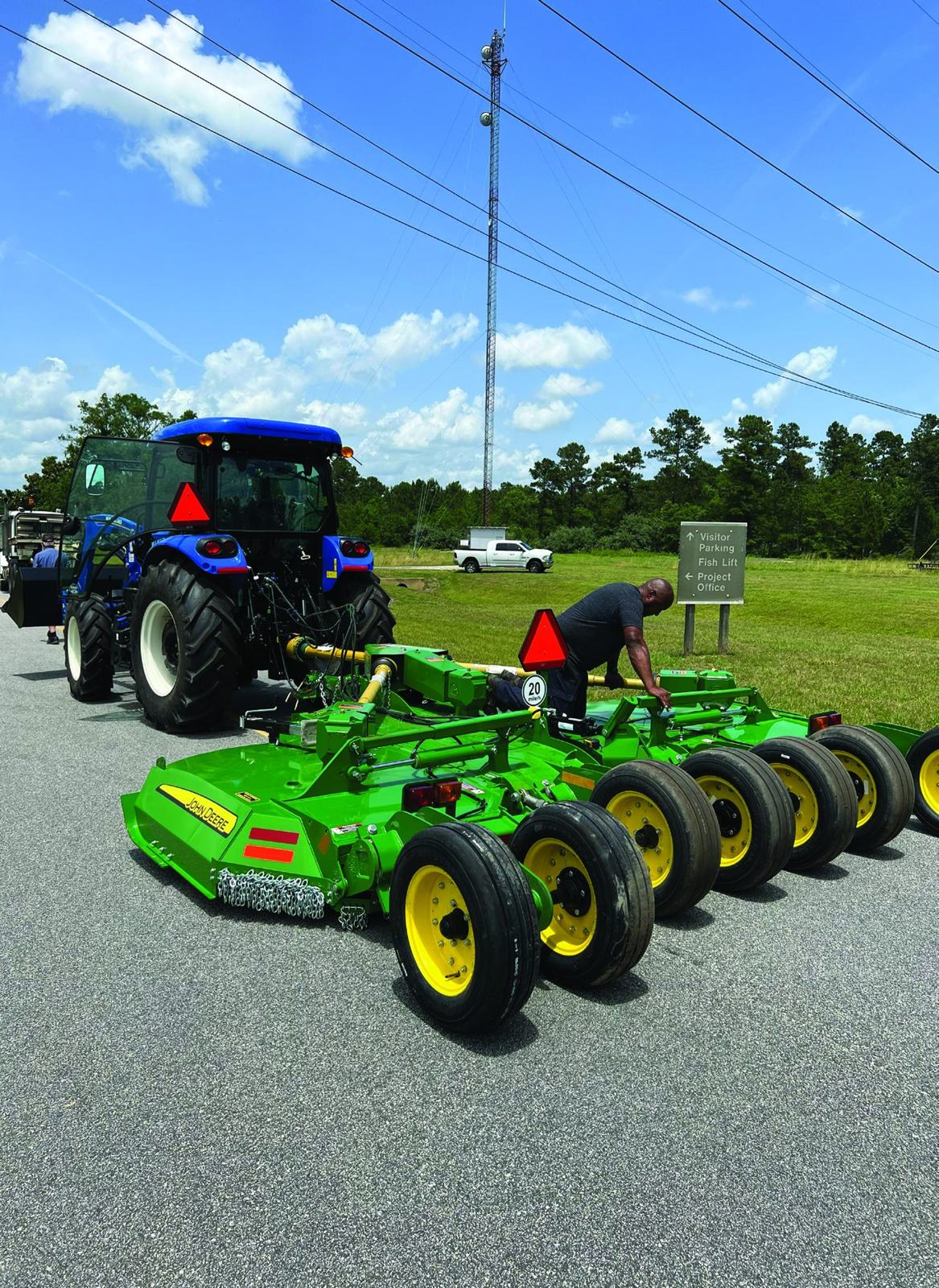 Tractor with a wide batwing mower at a Corps of Engineers site