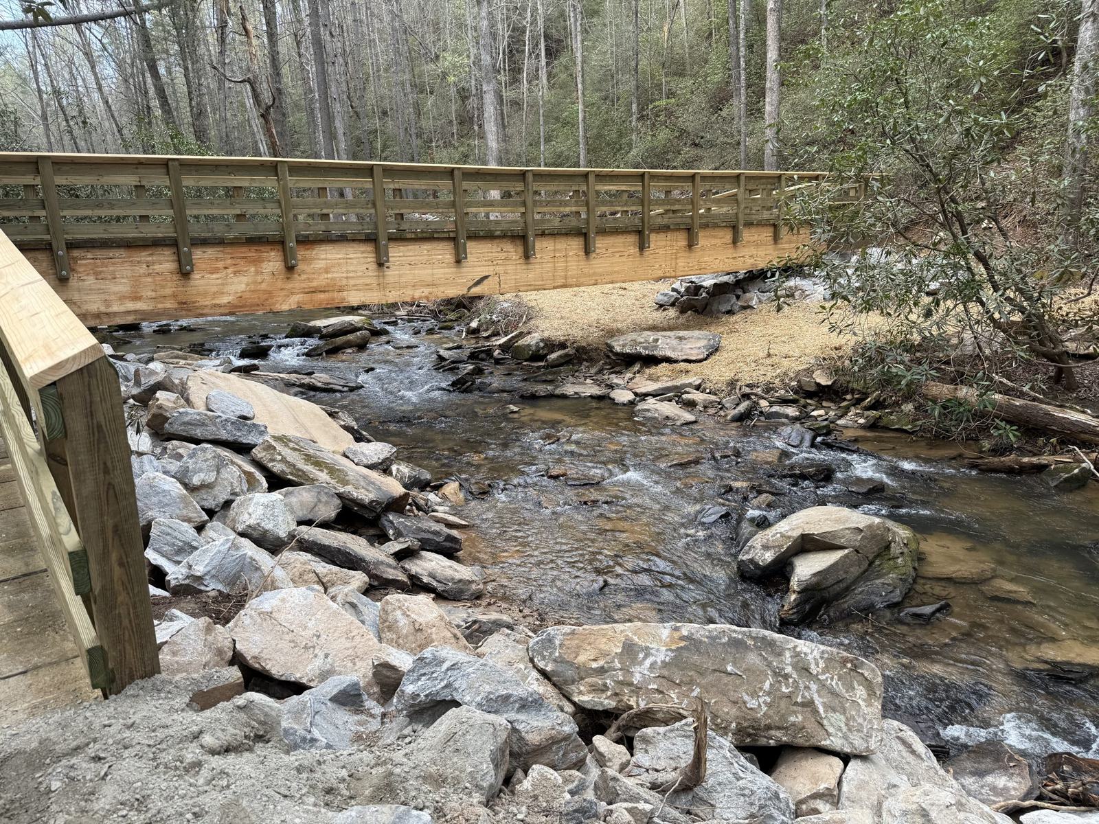 Finished timber trail bridge over a creek