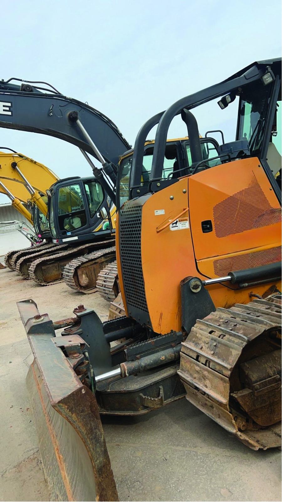 Dozer and excavators lined up in the equipment yard
